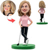 Glücklicher weiblicher Golfbobblehead im rosa Hemd